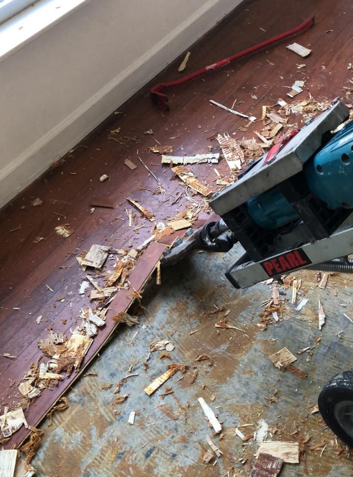 a machine with a handle on a wood floor